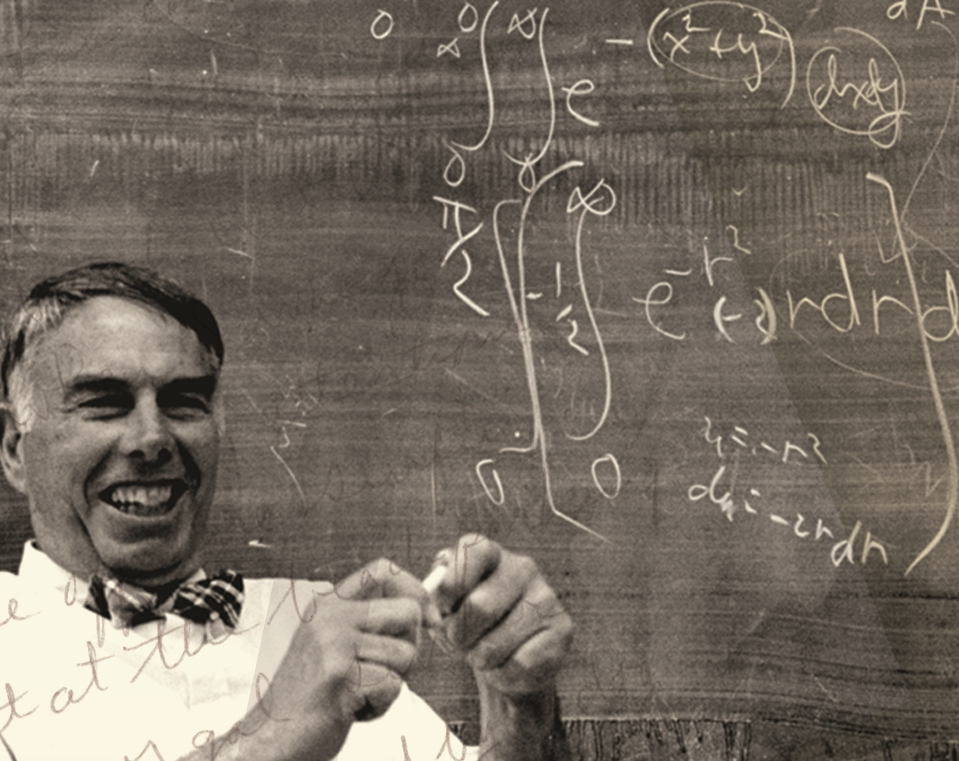 Joff similing in front a blackboard showing the final steps of computing the Gaussian integral.